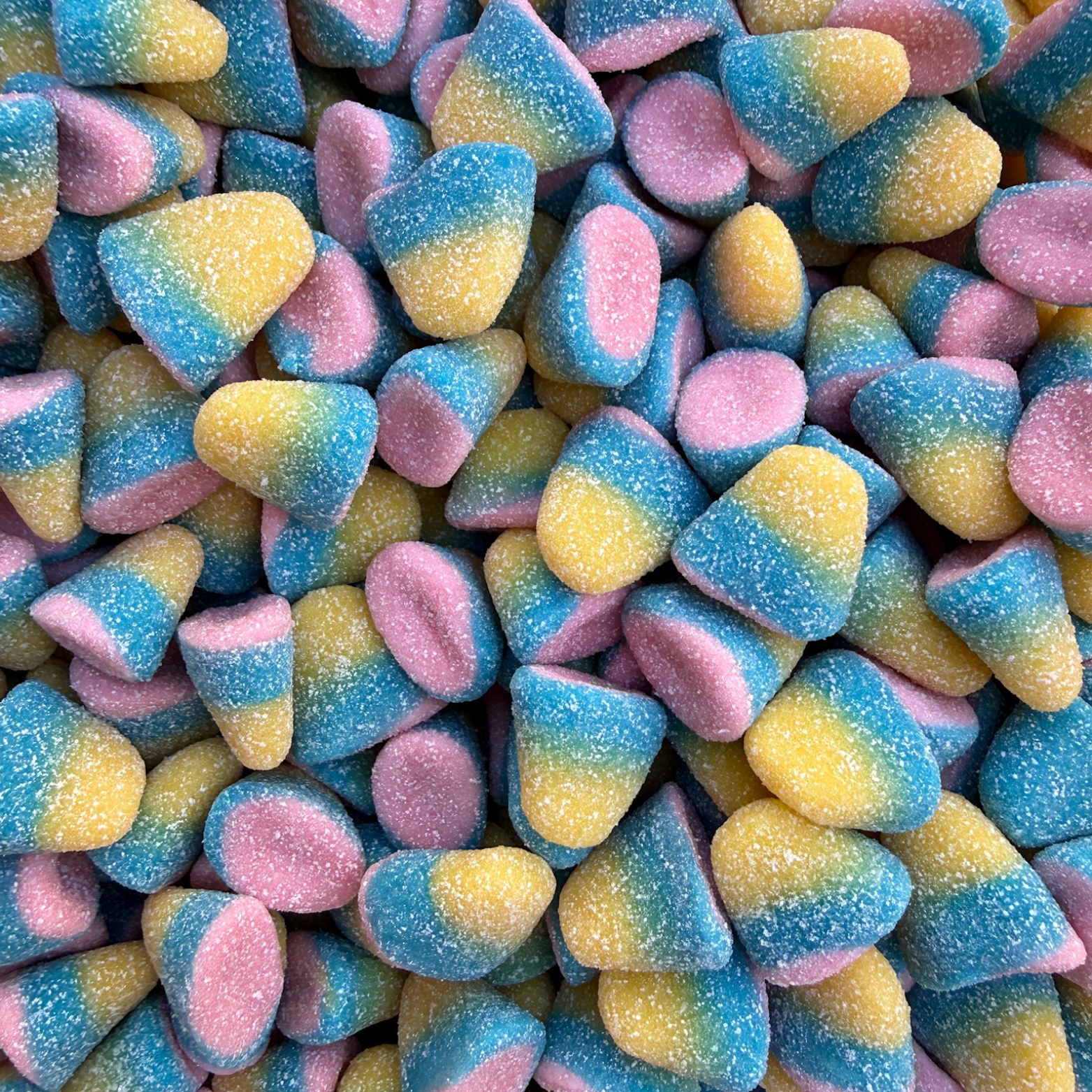 Colorful gummy candy with blue, yellow, and pink hues.