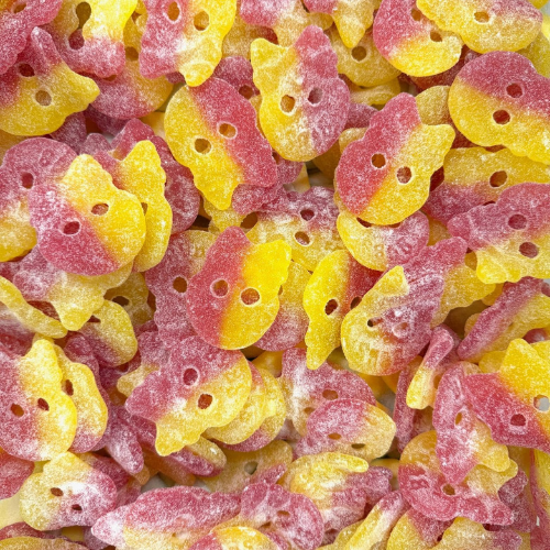 Close-up of pink and yellow gummy skulls.